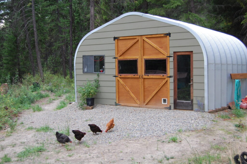 A model storage shed with custom endwall and wood doors and glass walk through with chickens in front